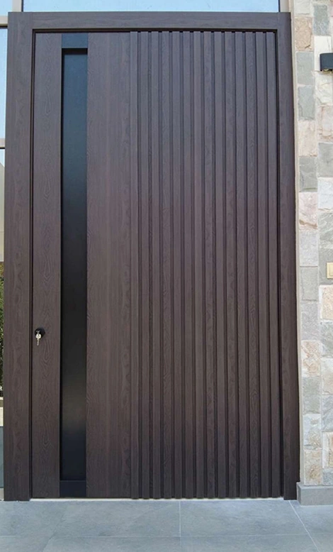 A dark door with closely spaced vertical ribs and a simple rectangular outline.