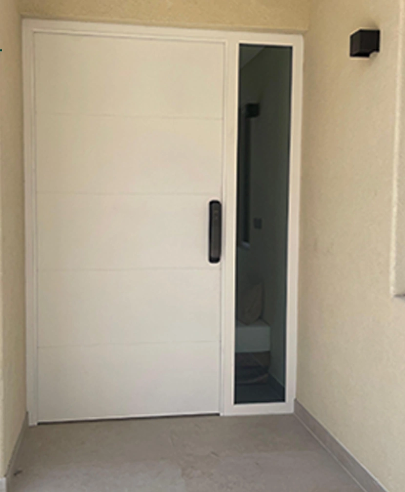 A white horizontal-panel entrance door paired with a narrow glazed sidelight.